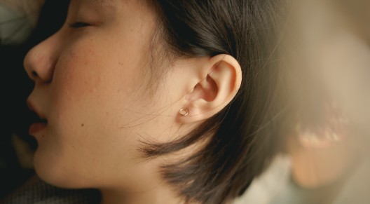girl sleeping on her side, closeup of ear