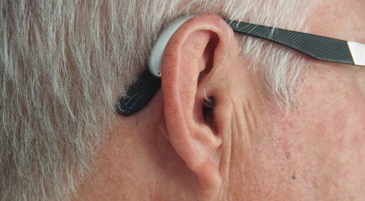 closeup of man's ear with hearing aid