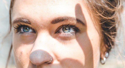 closeup of a person staring at the camera with a prominent nose