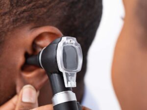 A doctor inspecting a woman's ear