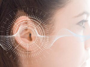 A diagram of sound bouncing off of a woman's ear