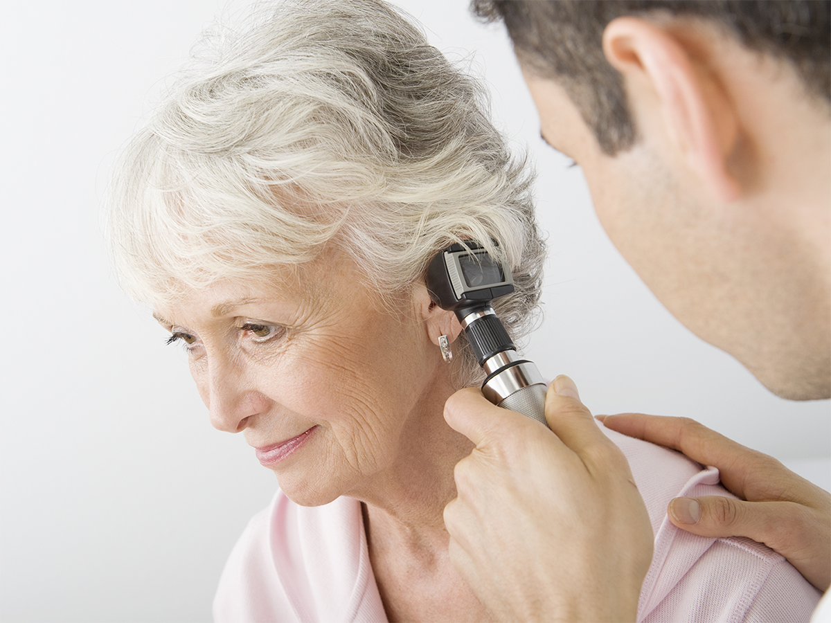 ENT doctor checking patient's ear