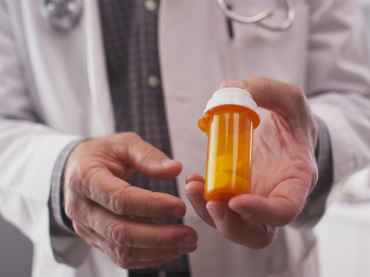 doctor holding prescriptions bottle