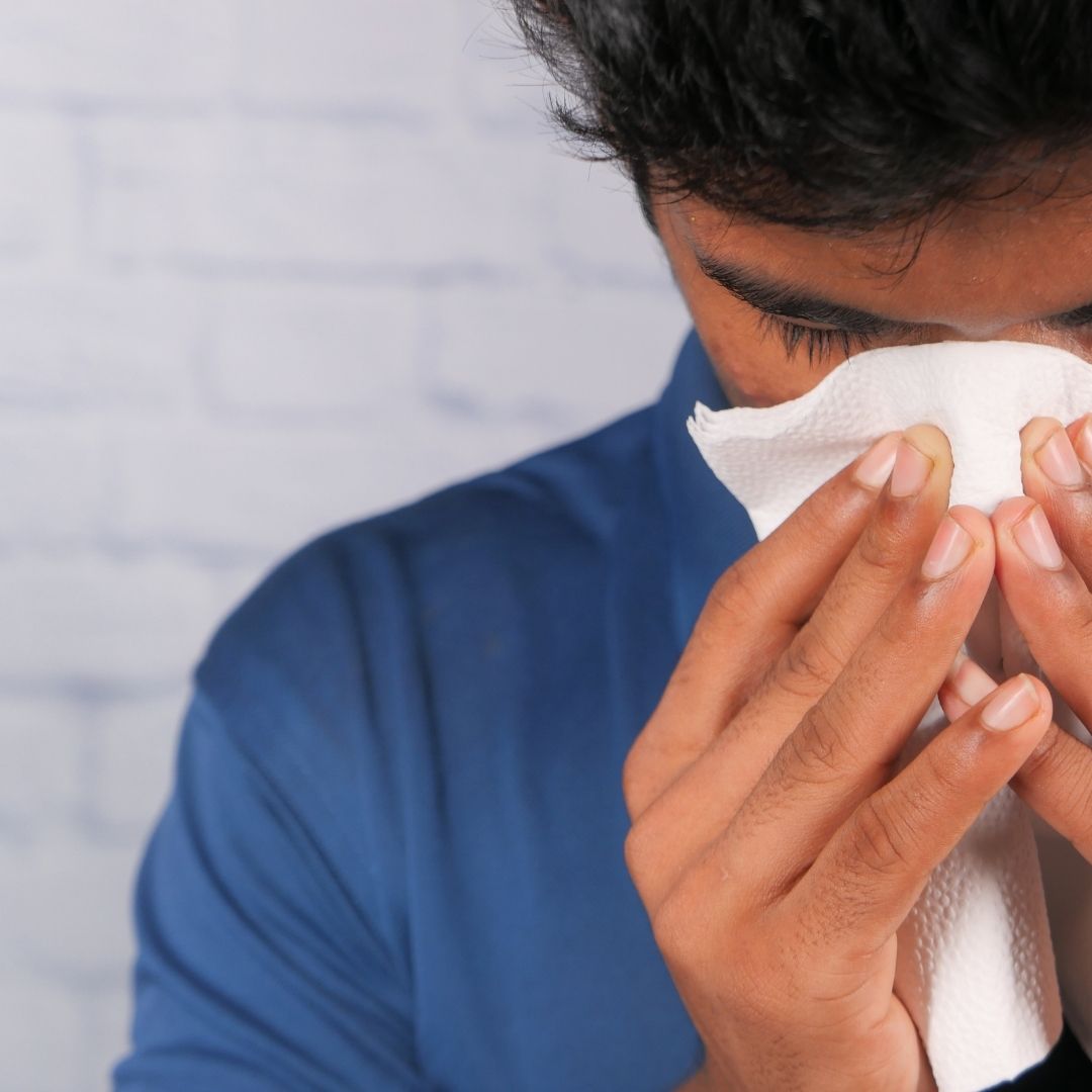 Man blowing his nose