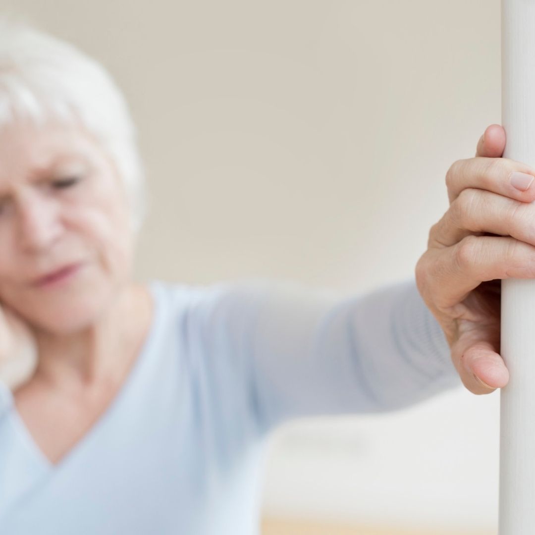 Woman bracing herself while feeling dizzy