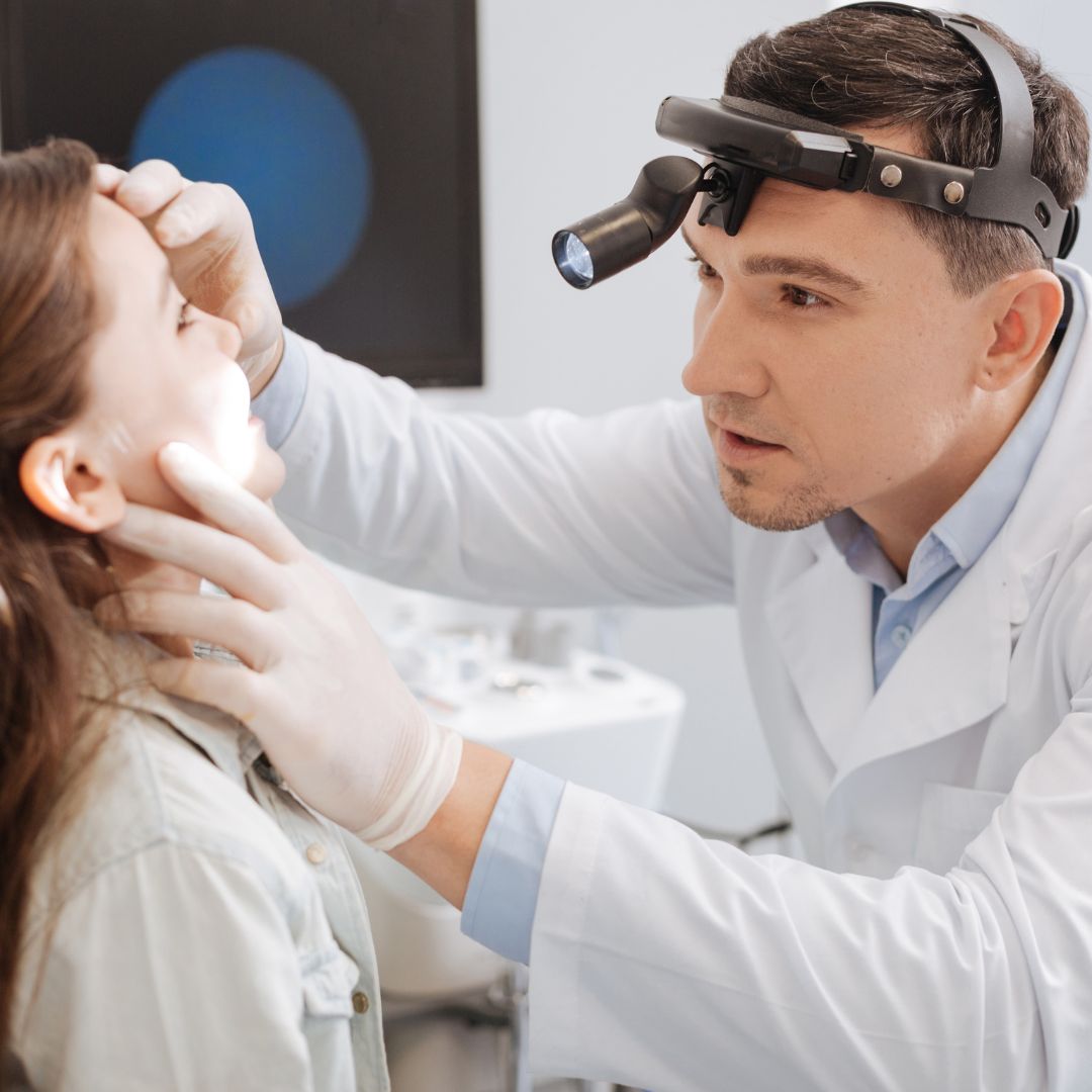 ENT doctor looking in child's mouth