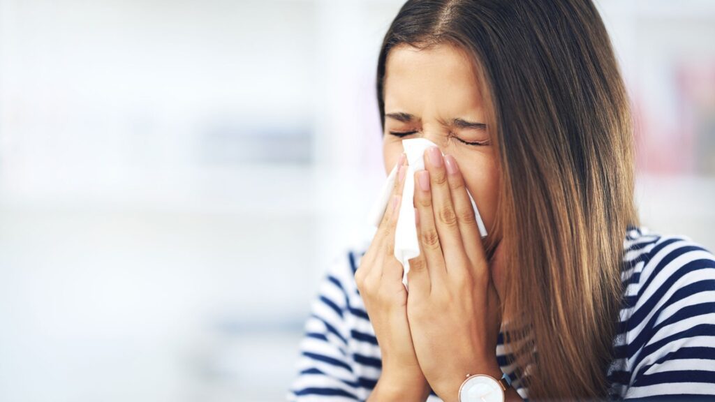 woman sneezing
