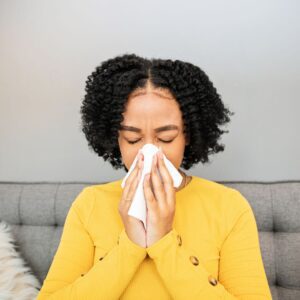 woman applying warm compress for sinus pressure relief