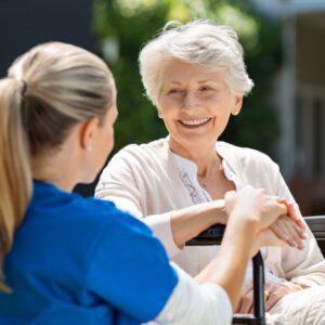 A nurse assisting an older woman