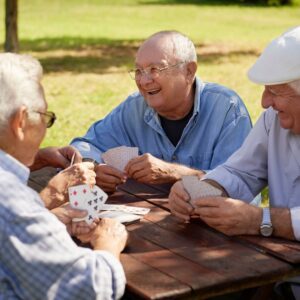 A group of older gentlemen playing cards together