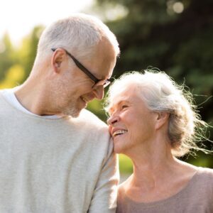 A couple of older adults smiling at each other