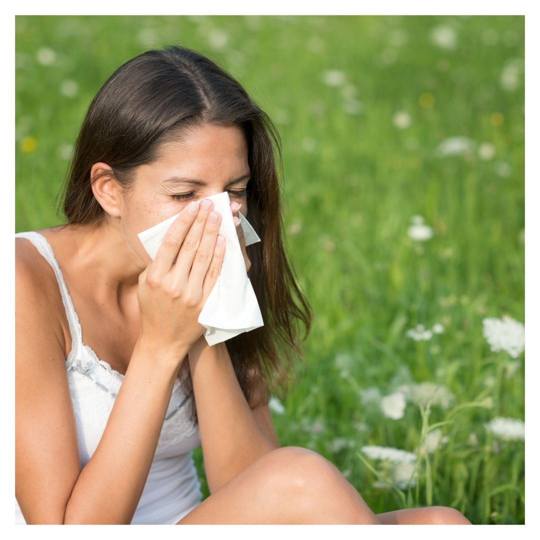 Woman blowing nose