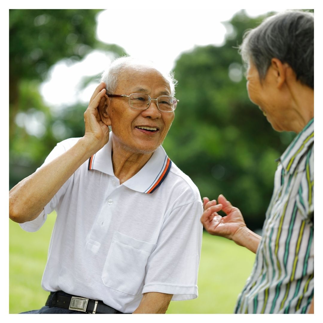 man cupping ear to listen
