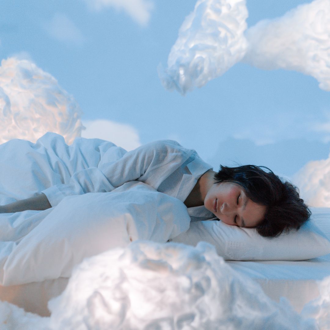 a woman sleeping on clouds