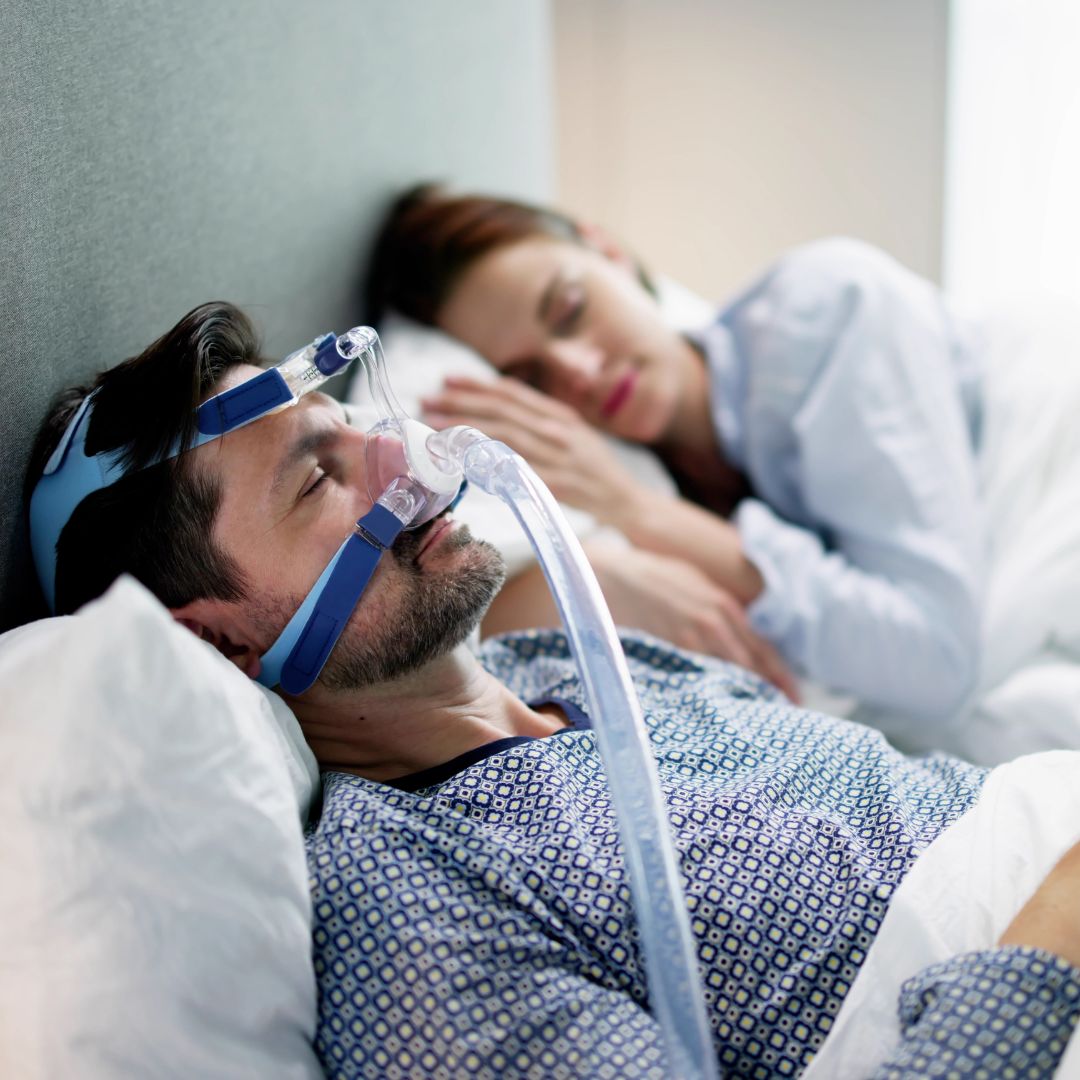 a man sleeping with a CPAP machine