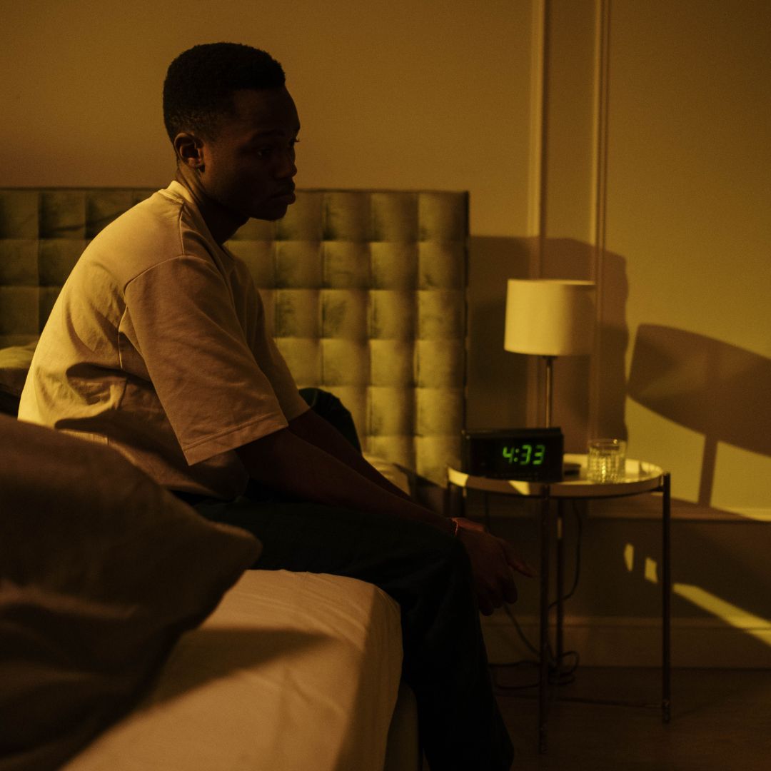 a man sitting in bed awake at 4am